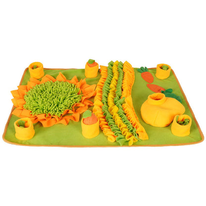 Orange and green fleece snuffle mat with ruffled strips and pumpkin/carrot-shaped fabric accents, laid flat on white.