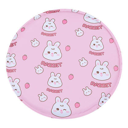 Round pet cooling mat in pink with a white rabbit and strawberry print pattern.
