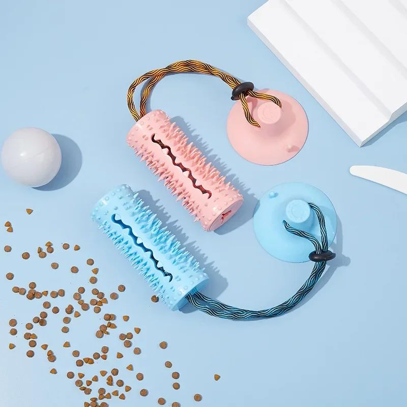 TugAnchor suction tug toy shown in pink and blue side by side with kibble
